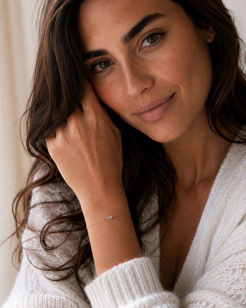 Woman wearing an emerald-cut lab-grown diamond bezel bracelet on her wrist.