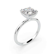 Side profile of an Asscher cut solitaire natural diamond ring in white gold, showing the raised four-prong setting.