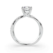     Side profile of a white gold X-shank round natural diamond engagement ring with pavé split band and four-prong setting on white background.