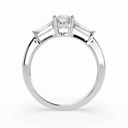 Side profile of a round natural diamond three-stone ring with tapered side stones in white gold