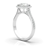 White gold round halo diamond ring with side stones, side view highlighting the halo setting, center diamond, and pavé band
