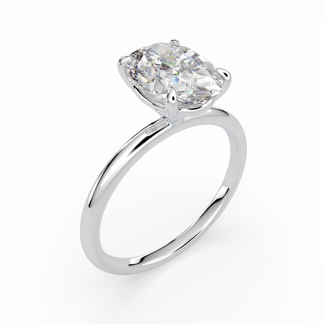 a white gold ring with a cushion shaped diamond